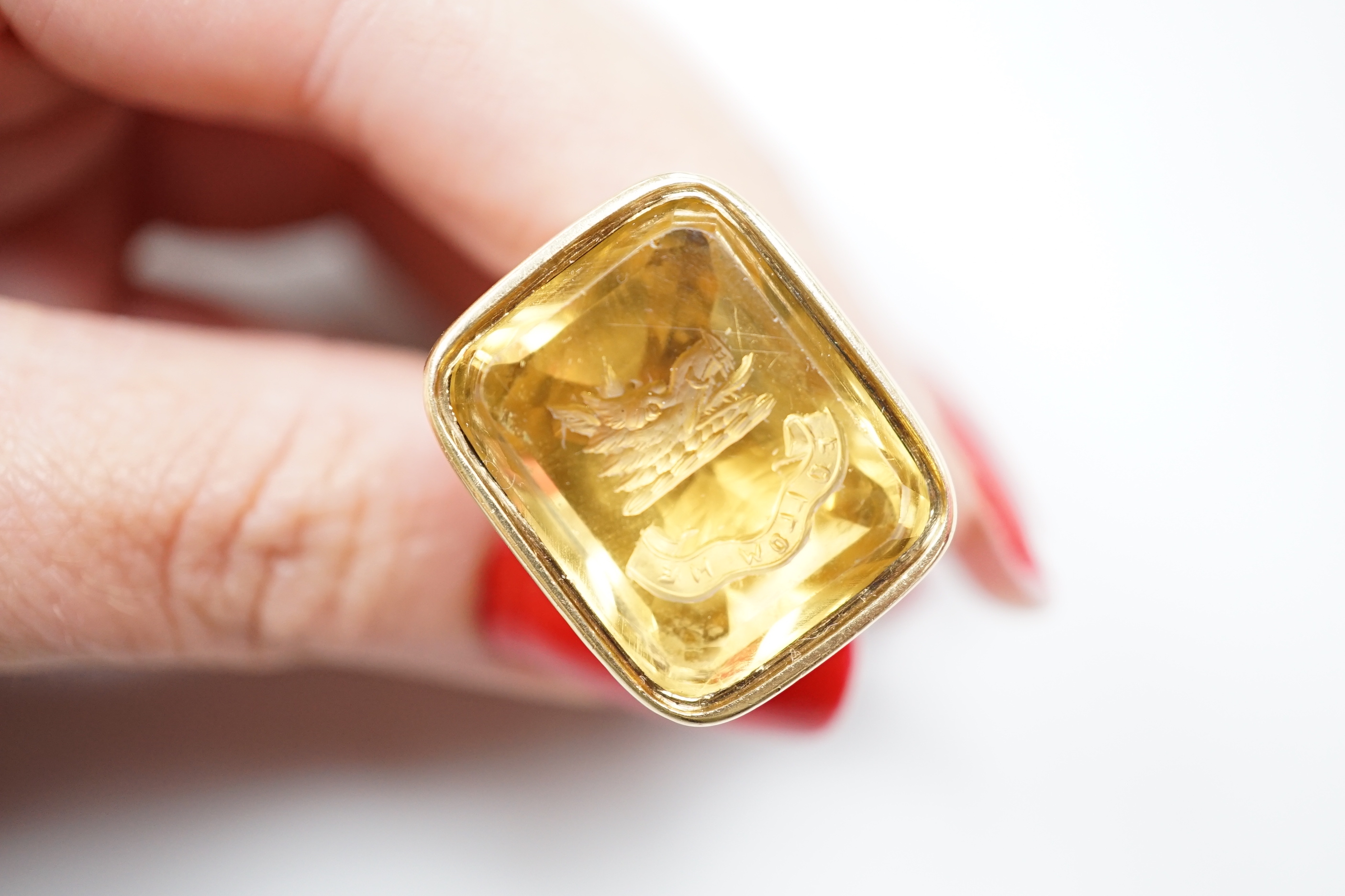An early 19th century gold overlaid fob seal, the matrix carved with a boars head crest and motto, height 4cm